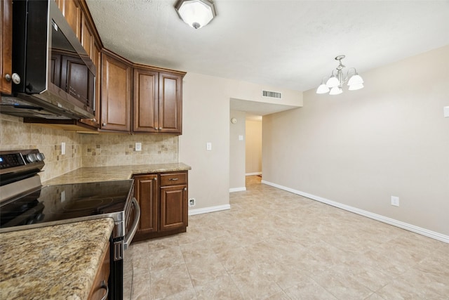 5109 Bartlett Dr, The Colony, TX 75056 - kitchen with stainless steel appliances, tasteful backsplash, a chandelier, decorative light fixtures, and light stone counters