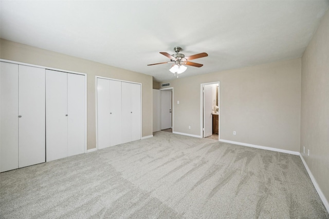 5109 Bartlett Dr, The Colony, TX 75056 - unfurnished bedroom featuring multiple closets, carpet, a ceiling fan, and connected bathroom