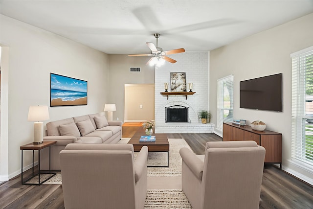 5109 Bartlett Dr, The Colony, TX 75056 - living area with dark wood finished floors, healthy amount of natural light, a brick fireplace, and ceiling fan