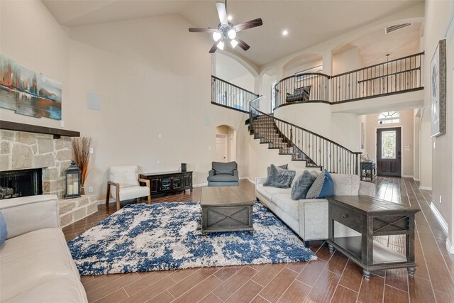 1220 Glendon Dr, Forney, TX 75126 - living room with stairs, arched walkways, high vaulted ceiling, ceiling fan, and wood tiled floors