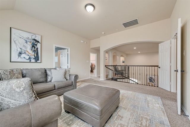 1220 Glendon Dr, Forney, TX 75126 - living area featuring arched walkways, carpet, and lofted ceiling