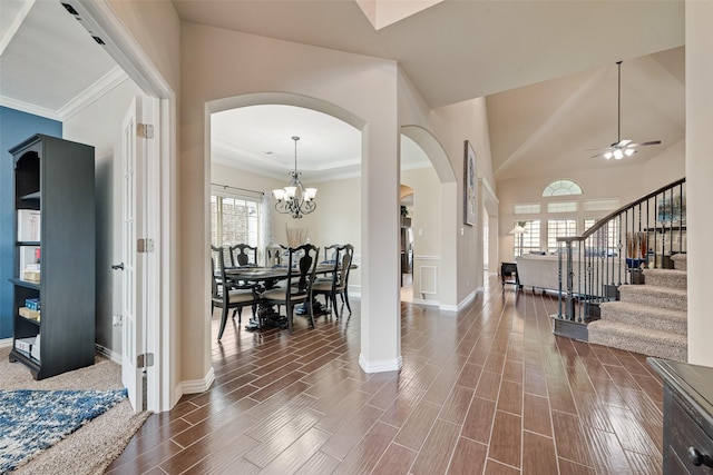 1220 Glendon Dr, Forney, TX 75126 - foyer entrance with arched walkways, stairway, ceiling fan, a chandelier, and dark wood-style floors