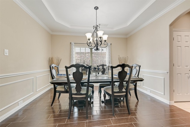 1220 Glendon Dr, Forney, TX 75126 - dining area with a chandelier, arched walkways, wood tiled floors, a raised ceiling, and a decorative wall
