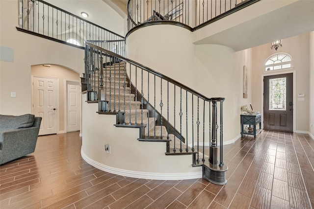 1220 Glendon Dr, Forney, TX 75126 - foyer entrance with a high ceiling, stairway, arched walkways, and wood finish floors