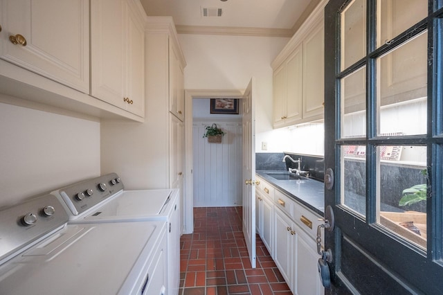 5906 Tiffany Ct, Arlington, TX 76016 - laundry area with brick patterned floors, washing machine and clothes dryer, cabinet space, and ornamental molding