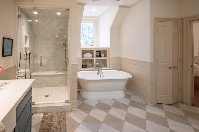 5906 Tiffany Ct, Arlington, TX 76016 - full bath featuring a soaking tub, a shower stall, vanity, wainscoting, and tile walls