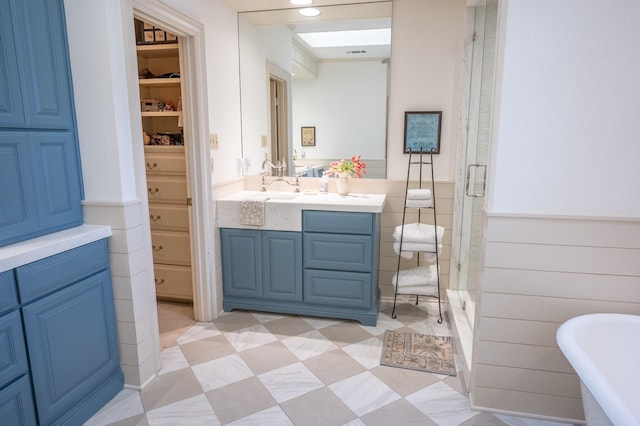 5906 Tiffany Ct, Arlington, TX 76016 - full bath with vanity, a stall shower, a closet, wainscoting, and a freestanding tub