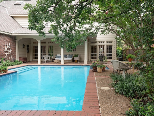 5906 Tiffany Ct, Arlington, TX 76016 - swimming pool with french doors, outdoor lounge area, and a patio area