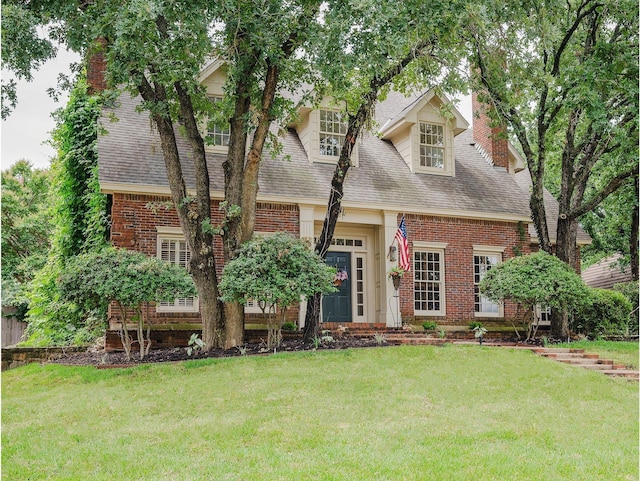 5906 Tiffany Ct, Arlington, TX 76016 - cape cod home with brick siding, a chimney, roof with shingles, and a front lawn