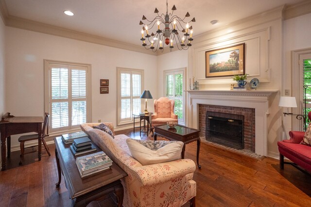 5906 Tiffany Ct, Arlington, TX 76016 - living room featuring dark wood finished floors, ornamental molding, a chandelier, a brick fireplace, and recessed lighting