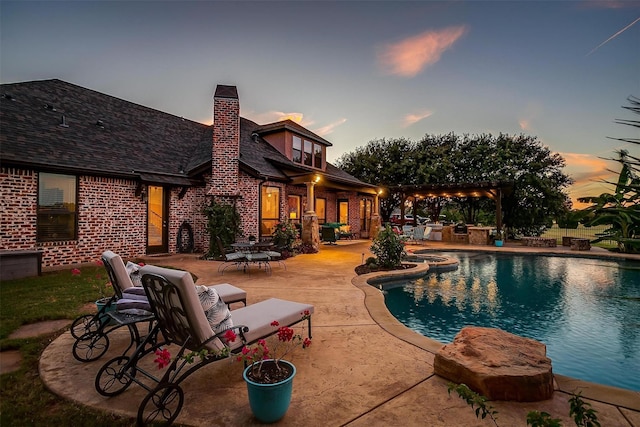 1204 E Scandinavian Ct, Granbury, TX 76048 - pool at dusk featuring a patio area and a pool with connected hot tub