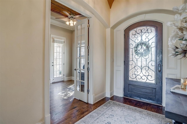 1204 E Scandinavian Ct, Granbury, TX 76048 - foyer with dark wood-style flooring, arched walkways, crown molding, and ceiling fan