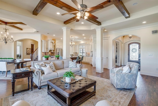 1204 E Scandinavian Ct, Granbury, TX 76048 - living area featuring coffered ceiling, healthy amount of natural light, ceiling fan, arched walkways, and beamed ceiling