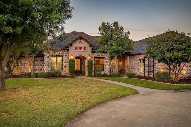 1204 E Scandinavian Ct, Granbury, TX 76048 - view of front of home featuring brick siding and a yard