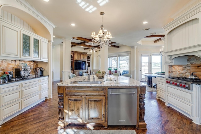 1204 E Scandinavian Ct, Granbury, TX 76048 - kitchen featuring stainless steel appliances, ornate columns, a chandelier, open floor plan, and light stone counters