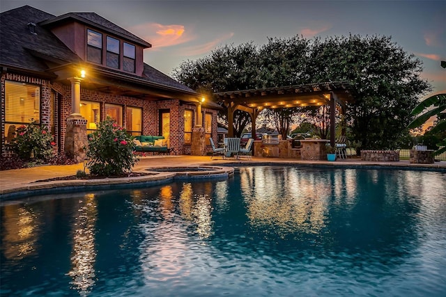 1204 E Scandinavian Ct, Granbury, TX 76048 - view of swimming pool with a patio area, a pool with connected hot tub, and exterior kitchen