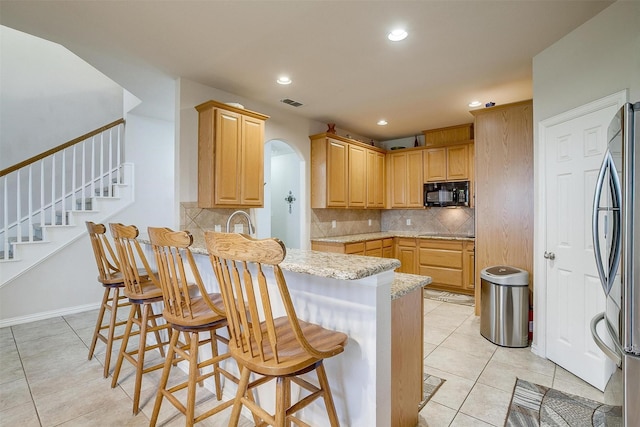 2536 Glenn Ranch Dr, Burleson, TX 76028 - kitchen with black appliances, arched walkways, light tile patterned floors, backsplash, and recessed lighting