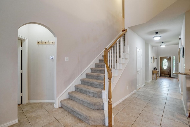 2536 Glenn Ranch Dr, Burleson, TX 76028 - staircase with arched walkways and tile patterned flooring
