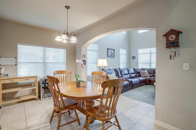 2536 Glenn Ranch Dr, Burleson, TX 76028 - dining room with arched walkways, light tile patterned flooring, and a chandelier