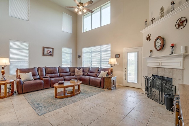 2536 Glenn Ranch Dr, Burleson, TX 76028 - living area with ceiling fan, light tile patterned floors, a high ceiling, and a tile fireplace