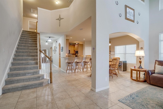 2536 Glenn Ranch Dr, Burleson, TX 76028 - entryway featuring a high ceiling, light tile patterned floors, arched walkways, and stairs
