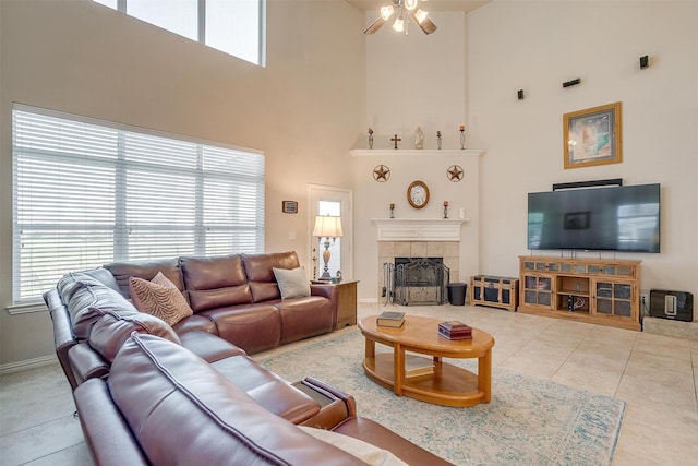 2536 Glenn Ranch Dr, Burleson, TX 76028 - tiled living area with a high ceiling, ceiling fan, plenty of natural light, and a tile fireplace