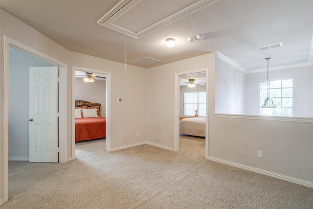 2536 Glenn Ranch Dr, Burleson, TX 76028 - carpeted spare room featuring attic access, ornamental molding, and ceiling fan