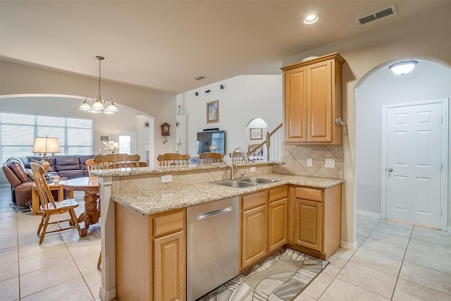 2536 Glenn Ranch Dr, Burleson, TX 76028 - kitchen with open floor plan, stainless steel dishwasher, arched walkways, light tile patterned floors, and a peninsula