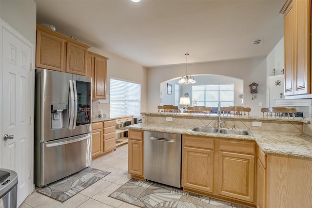 2536 Glenn Ranch Dr, Burleson, TX 76028 - kitchen featuring stainless steel appliances, plenty of natural light, arched walkways, and light tile patterned floors
