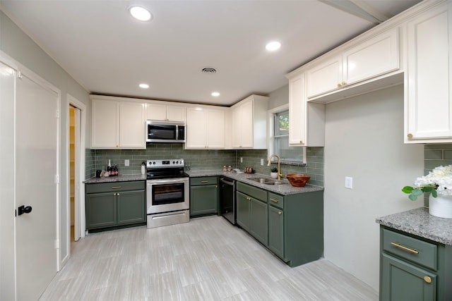 6817 Yolanda Dr, Fort Worth, TX 76112 - kitchen featuring stainless steel appliances, green cabinetry, white cabinets, tasteful backsplash, and light stone countertops