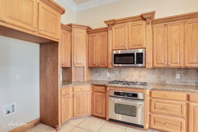 902 Blair Xing, Bossier City, LA 71111 - kitchen with stainless steel appliances, crown molding, light stone counters, backsplash, and light tile patterned floors