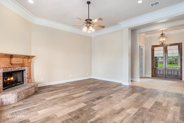 902 Blair Xing, Bossier City, LA 71111 - unfurnished living room with a chandelier, crown molding, light wood-style floors, a brick fireplace, and a ceiling fan