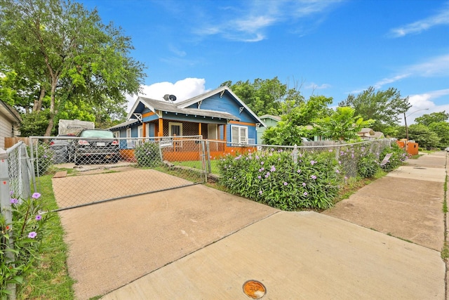 1342 E Waco Ave, Dallas, TX 75216 - bungalow-style house with a fenced front yard, concrete driveway, and a gate