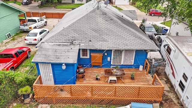 1342 E Waco Ave, Dallas, TX 75216 - rear view of house with a shingled roof and a wooden deck
