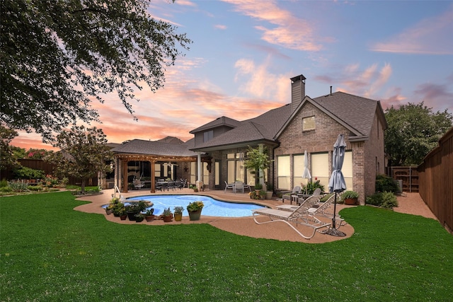 4263 Veneto Dr, Frisco, TX 75033 - rear view of property featuring a patio area, brick siding, a fenced backyard, a chimney, and a shingled roof