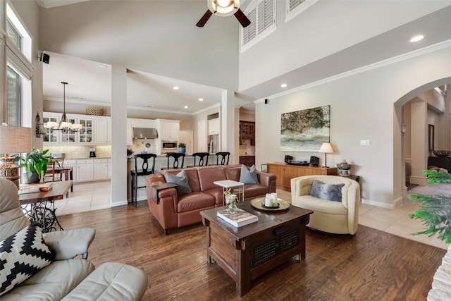 4263 Veneto Dr, Frisco, TX 75033 - living room featuring ceiling fan, arched walkways, crown molding, a high ceiling, and recessed lighting