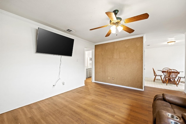 803 Melody Cir, Kaufman, TX 75142 - living area with wood finished floors, a ceiling fan, and crown molding