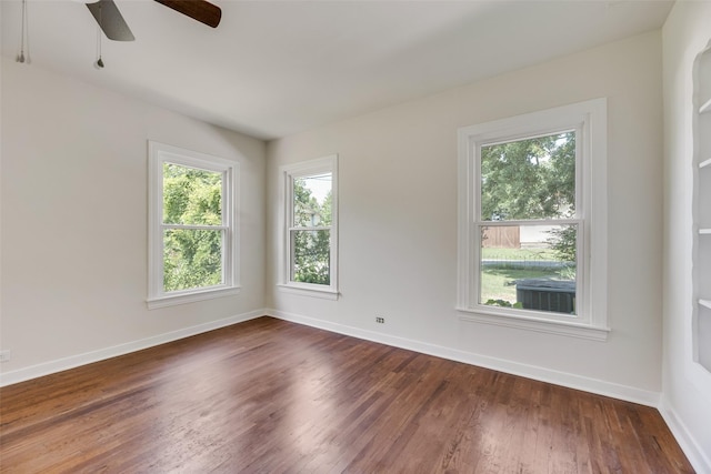 103 E 14th St, Joshua, TX 76058 - spare room featuring a ceiling fan and dark wood-style flooring