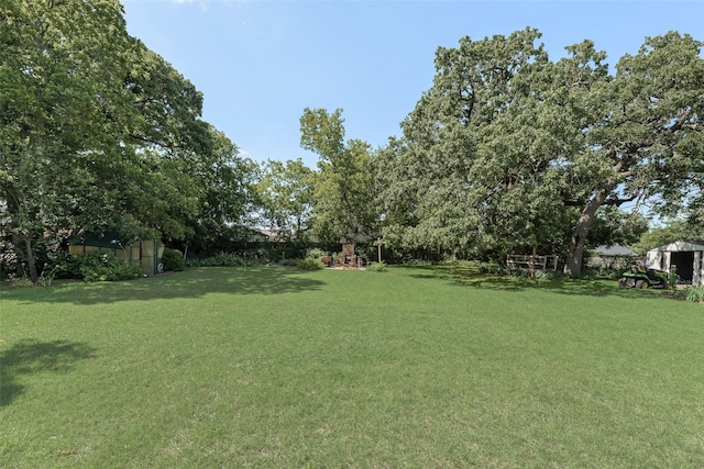 103 E 14th St, Joshua, TX 76058 - view of grassy yard featuring a storage shed