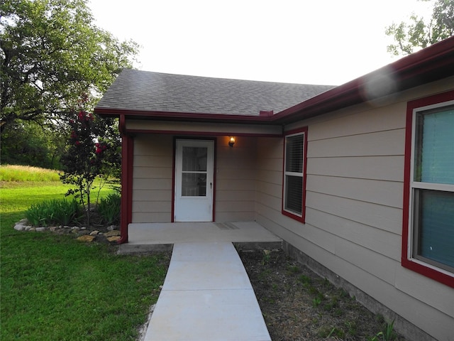 128 Siesta Ct, Granbury, TX 76048 - property entrance featuring a shingled roof and a yard