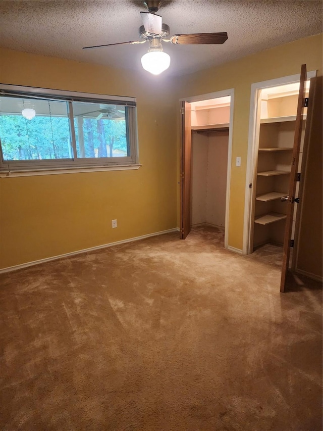 34 Sunset Blvd, Star Harbor, TX 75148 - unfurnished bedroom featuring a textured ceiling, carpet floors, two closets, and a ceiling fan