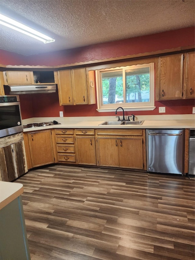 34 Sunset Blvd, Star Harbor, TX 75148 - kitchen with stainless steel appliances, under cabinet range hood, dark wood-type flooring, a textured ceiling, and light countertops