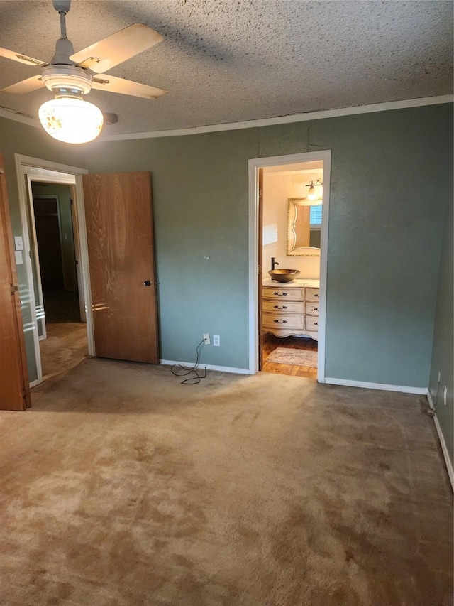 34 Sunset Blvd, Star Harbor, TX 75148 - unfurnished bedroom featuring ornamental molding, carpet floors, ensuite bathroom, a textured ceiling, and a ceiling fan