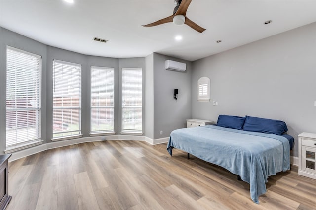 11722 Estacado Dr, Frisco, TX 75033 - bedroom with a wall mounted AC, light wood finished floors, recessed lighting, and ceiling fan