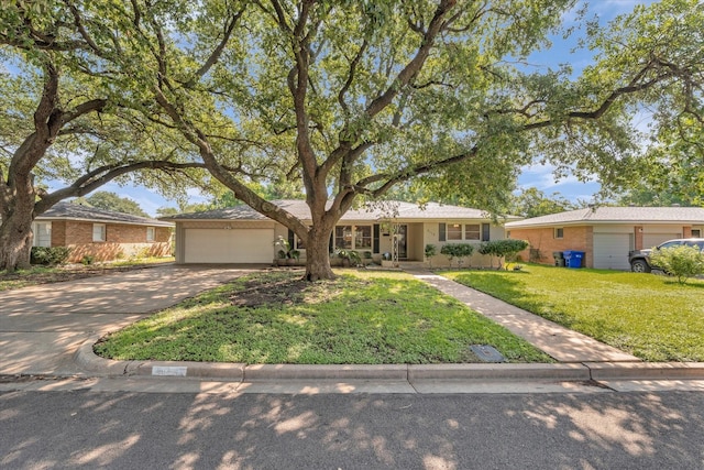 2113 Trinity Dr, Waco, TX 76710 - ranch-style home with concrete driveway, a garage, a front yard, and brick siding