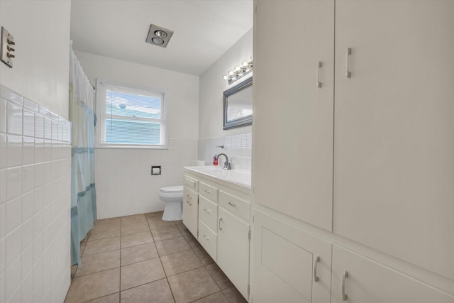 2113 Trinity Dr, Waco, TX 76710 - full bathroom featuring tile walls, tile patterned flooring, vanity, and wainscoting