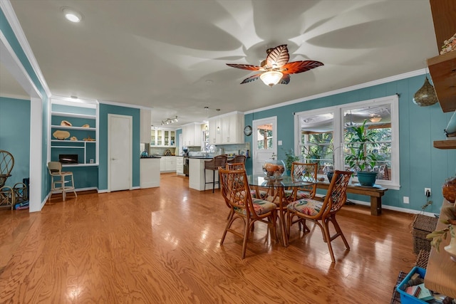2113 Trinity Dr, Waco, TX 76710 - dining area featuring ornamental molding, ceiling fan, light wood-style floors, and built in features