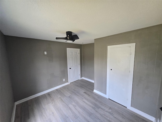 130 Jackson St N, Sulphur Springs, TX 75482 - unfurnished bedroom featuring wood finished floors, a textured ceiling, and ceiling fan