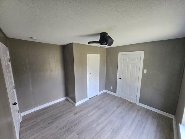 130 Jackson St N, Sulphur Springs, TX 75482 - unfurnished bedroom featuring wood finished floors, a textured ceiling, a ceiling fan, and a closet