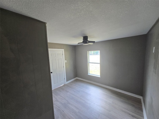 130 Jackson St N, Sulphur Springs, TX 75482 - spare room with wood finished floors, ceiling fan, and a textured ceiling